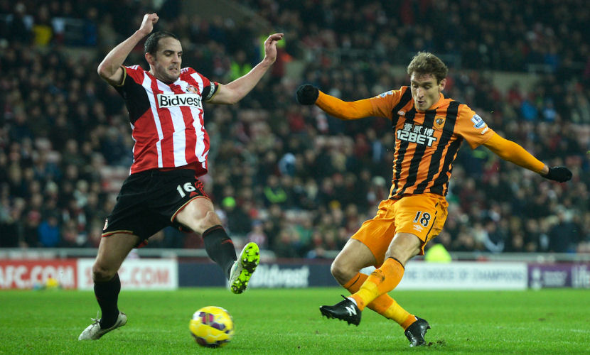 SUNDERLAND, ENGLAND - DECEMBER 26: Nikica Jelevic of Hull City scores his team's third goal despite the efforts of John O'Shea of Sunderland during the Barclays Premier League match between Sunderland and Hull City at the Stadium of Light on December 26, 2014 in Sunderland, England. (Photo by Nigel Roddis/Getty Images)
